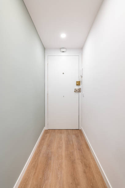 istock White corridor with entrances to a bright room and doors in an empty apartment before moving or after renovation. Concept of renovation and moving into compact new apartment. Copyspace 2185207189