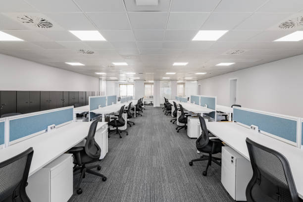 istock Spacious empty office in grey colors with comfortable office furniture without equipment with areas for employees of different directions. Concept of modern corporate space in a city business center 2185207660