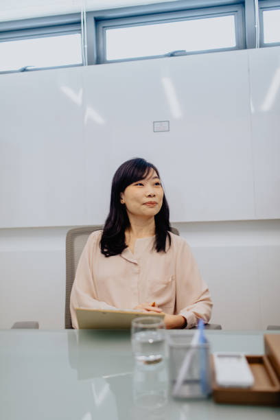 istock Woman Listening And Taking Notes During Meeting 2185208346