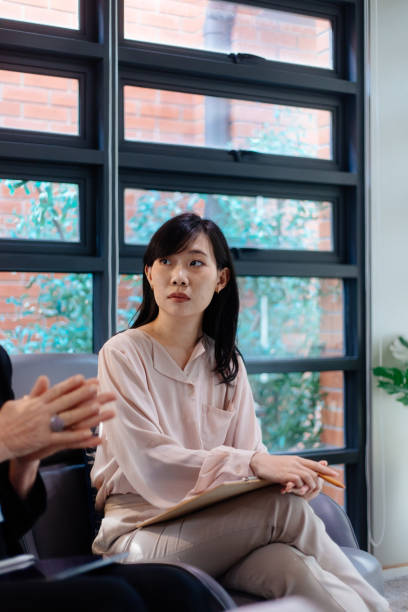 istock Woman Listens With Clipboard During Meeting 2185208454