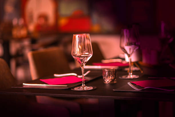 istock Elegant Dining Table Setting with Wine Glasses in Warm Lighting 2185209171