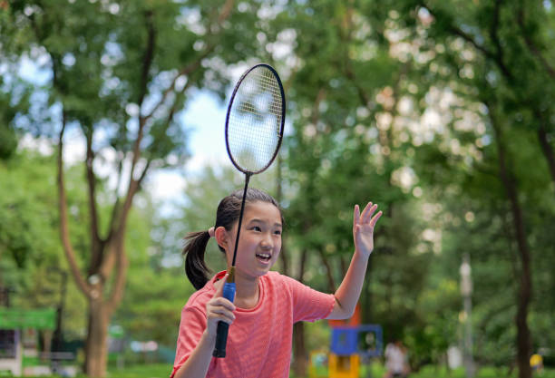 Little girl play badminton