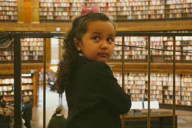 A girl standing in a library