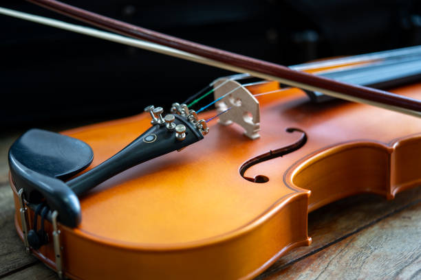 istock Music instrument violin macro in a wooden table 2185209703