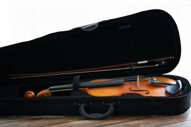 istock Music instrument violin macro in a wooden table 2185209709