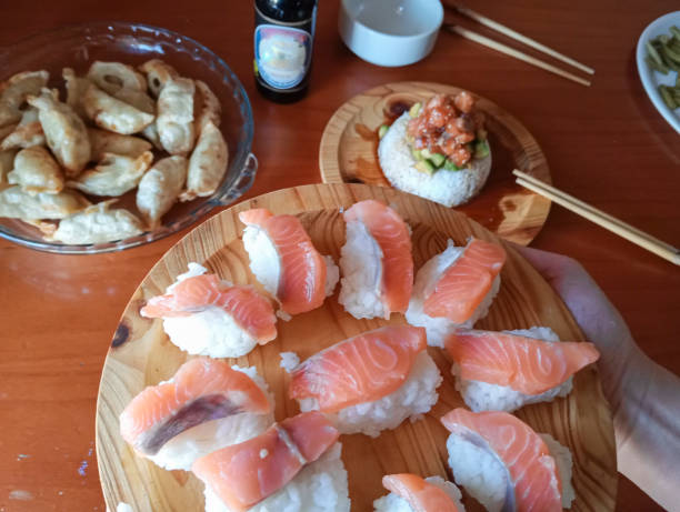Close-up of Japanese food based on rice and fresh salmon. Sushi and sashimi
