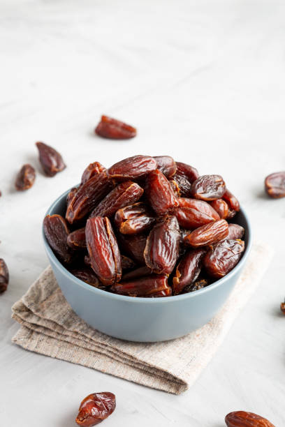 istock Pitted Organic Dates in Bowl on gray background, side view. Copy space. 2185211780