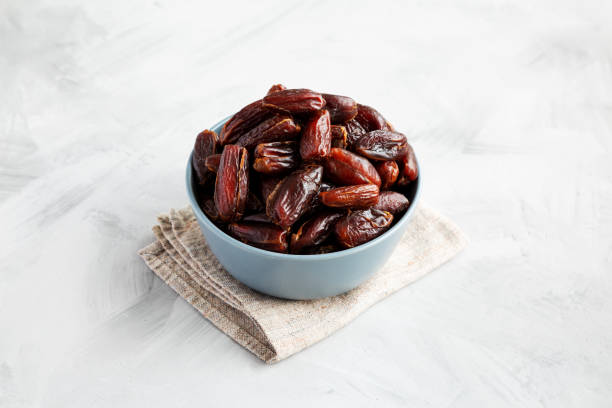 istock Pitted Organic Dates in Bowl on gray background, side view. 2185211805