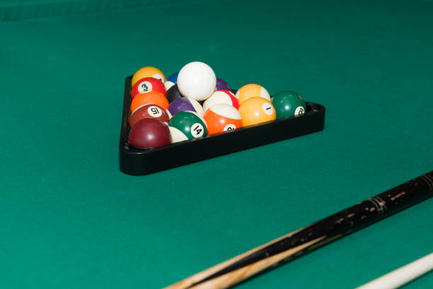 istock Billiard balls and a cue on a green cloth table. 2185212119