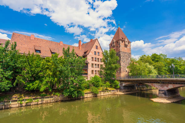 View of Nürnberg Old Town featuring the River Pegnitz, Heubrücke, Schuldturm and other old buildings.