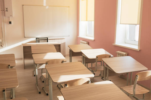 istock a school classroom with windows, good lighting and desks for students 2185213865