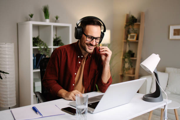 istock Freelancer working from home having a business video call using laptop and headphones 2185214610