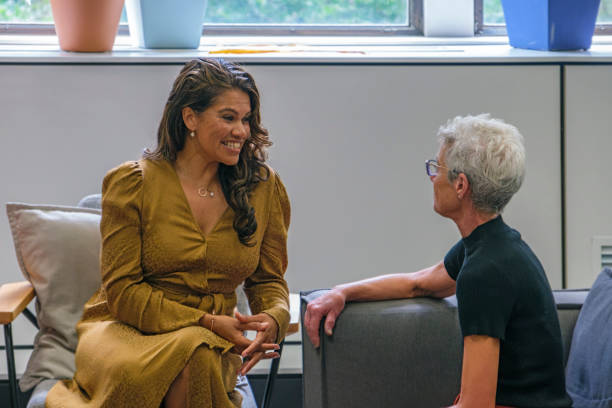 istock Two business women chatting in lounge area during a break from work 2185217338