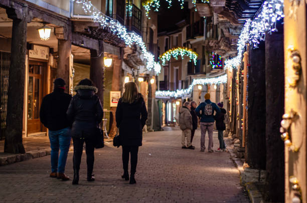 Walk at night with streets decorated with Christmas decorations and decorations and a multitude of lights, Medina de Rioseco, Valladolid, Castilla y Leon, Spain - December 8, 2023