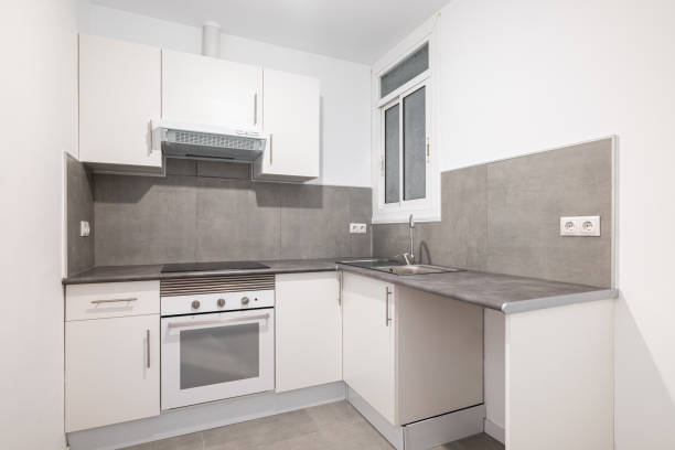 istock Light compact kitchen with stove, extractor hood and sink and window. Concept of kitchen in a small apartment. Modern minimalist design in new buildings 2185218697