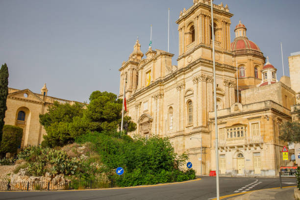 Old Mint Street Teeming With Bay Windows And St. Dominic Basilica In Valletta, Malta