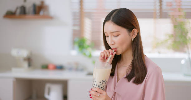 istock woman drink bubble tea home 2185220154