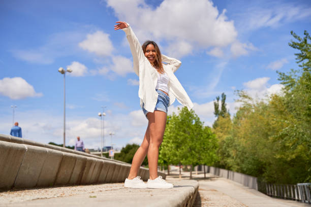 istock A Latina woman performs various dance poses in a park, 2185220621