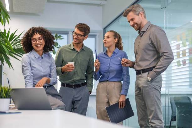 istock Group of young modern people in formalwear using modern technologies while working in the creative office 2185223740