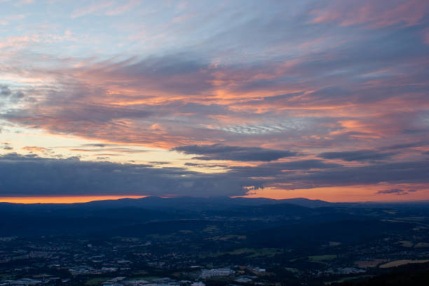 dawn against the backdrop of mountains and a small town