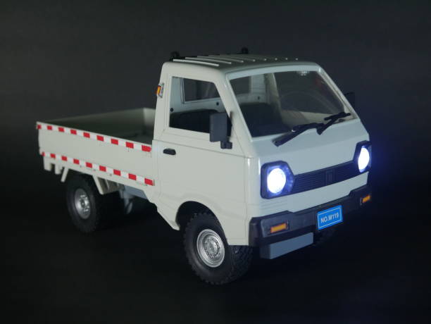 istock A small white pickup truck showcased on a dark surface. 2185225593