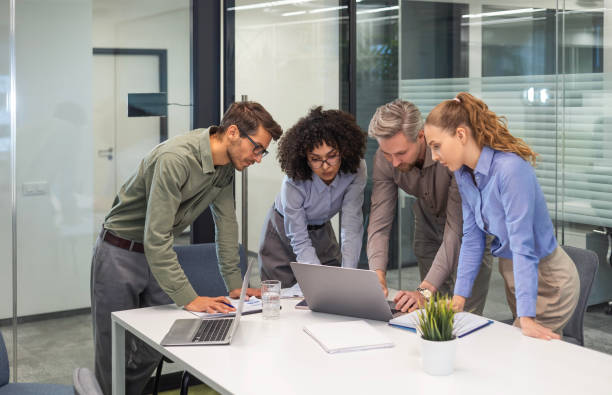 istock Startup business team on meeting in modern bright office interior and working on laptop 2185226157