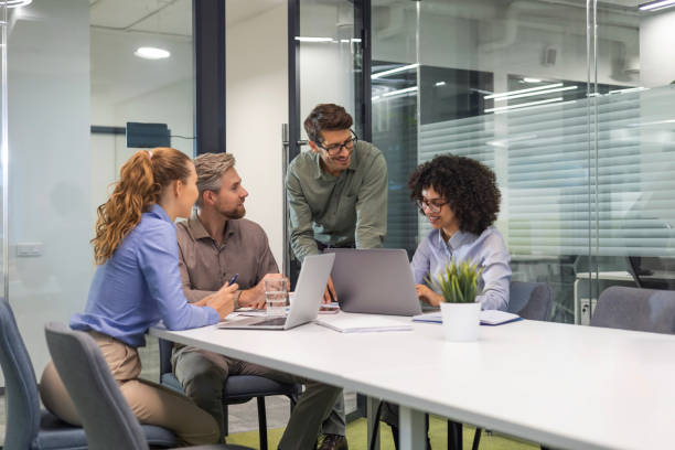 istock Group of young modern people in formalwear using modern technologies while working in the creative office 2185226423
