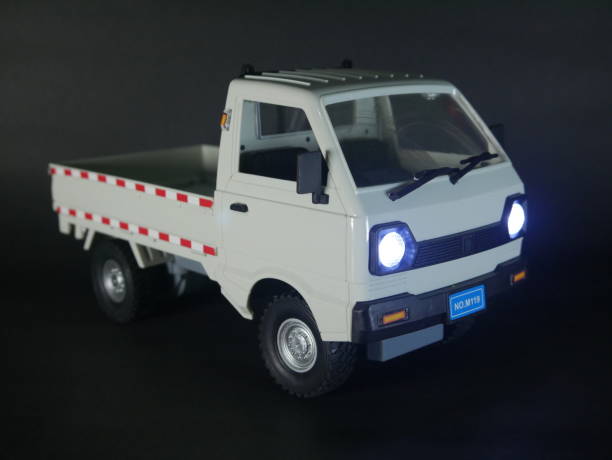 istock A miniature white pickup truck displayed on a dark background. 2185227099