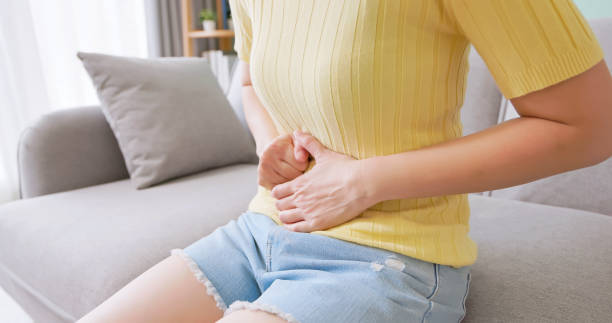 istock asian woman has belly pain 2185229183