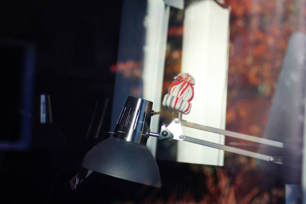 A desk lamp with a little Christmas hat on it