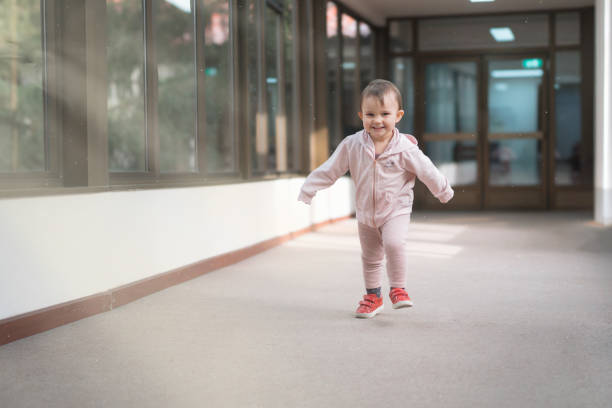Happy Toddler Running Indoors in a Bright Hallway