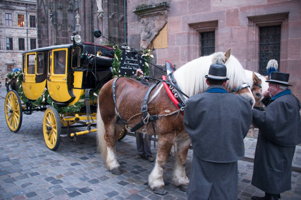 Nuremberg, Germany - December 14, 2013: Drivers of a horse car, caring for the animals, in a historic town square