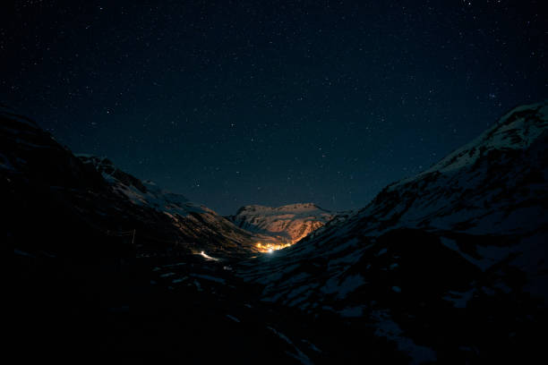 istock Lights of small settlements in snowy mountains 2185232415