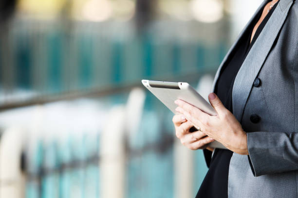 istock Unrecognizable businesswoman is using a digital tablet. 2185232420