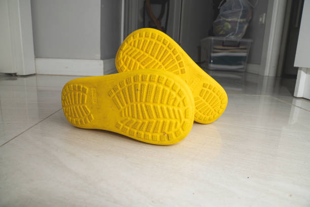 Yellow children's boots on the ground.