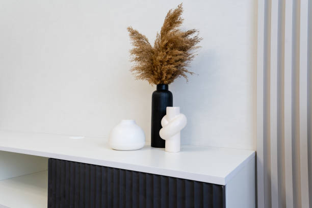 istock Explore the world of modern home decor featuring elegant vases and beautifully arranged dried floral displays, perfect for enhancing minimalist interior designs 2185236043