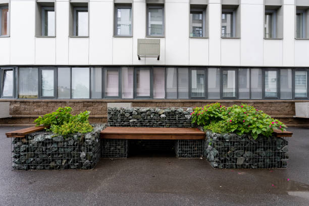 The image showcases a prominent building that features a bench and decorative planters situated right in front of it, creating a welcoming atmosphere for passersby and visitors alike