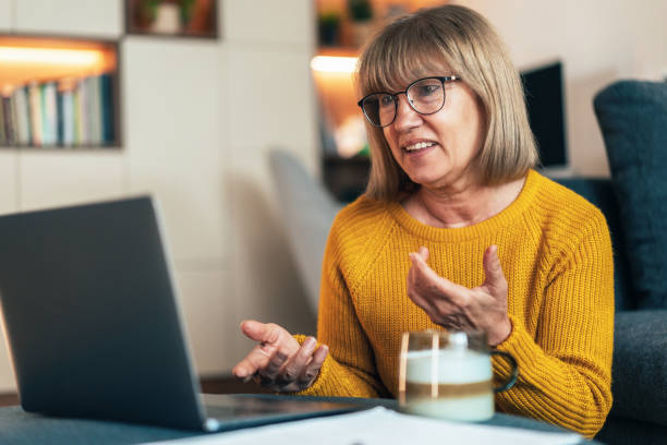 istock Senior woman having video call 2185236941