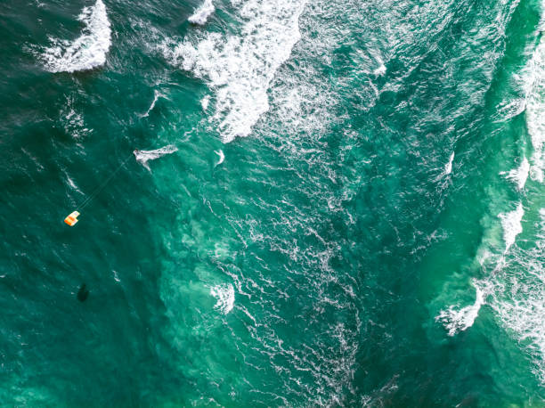 istock Top down view of kitesurfer riding on waves at Sea. 2185238777
