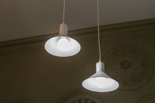 istock Glowing pendant lights with LED lamps suspended by long cords 2185238852