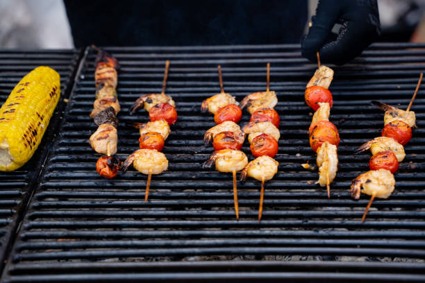 istock A delicious grill featuring an array of plump shrimp, fresh tomatoes, and sweet corn on the cob perfectly positioned on it, ready to be enjoyed in a delightful outdoor setting 2185239280