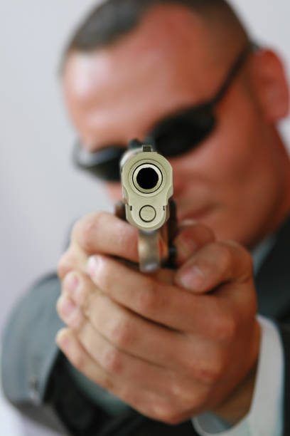 Portrait Of Criminal Wearing Mask Against Gray Background
