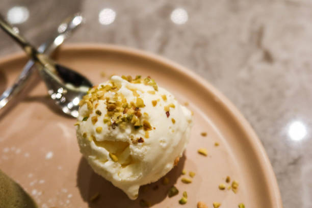 close up of vanilla ice cream with pistachio nuts toppings