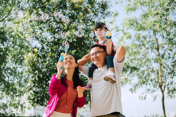 istock Asian Chinese family playing bubbles in public park 2185241725
