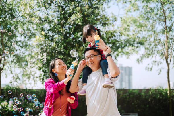 istock Asian Chinese family playing bubbles in public park 2185241730