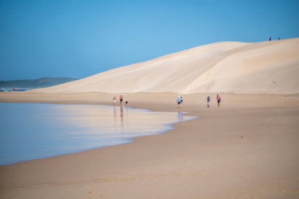 istock Landscape with people seen walking along the coast 2185246391
