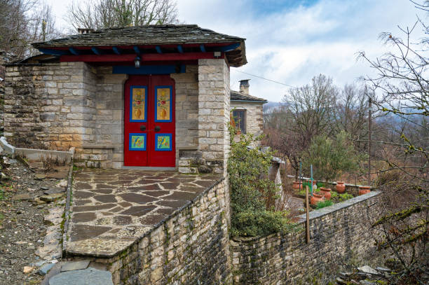 Stone house with painted door at the traditional village of Dilofo at the area of Zagori in Epirus, Greece
