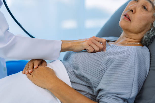 istock Doctor examining patient with stethoscope during consultation during home visit Doctor using stethoscope to check heart rate of female patient Medical assistance 2185251073