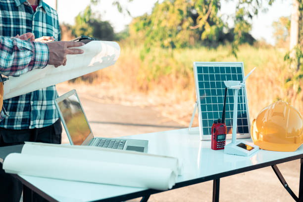 istock Meeting with engineers about wind turbine models and house models. Concepts for housing development and renewable energy The team wore safety gear. Talk about installation plans Check the working system solar panel 2185251184