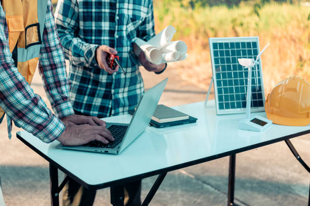 istock Meeting with engineers about wind turbine models and house models. Concepts for housing development and renewable energy The team wore safety gear. Talk about installation plans Check the working system solar panel 2185251217